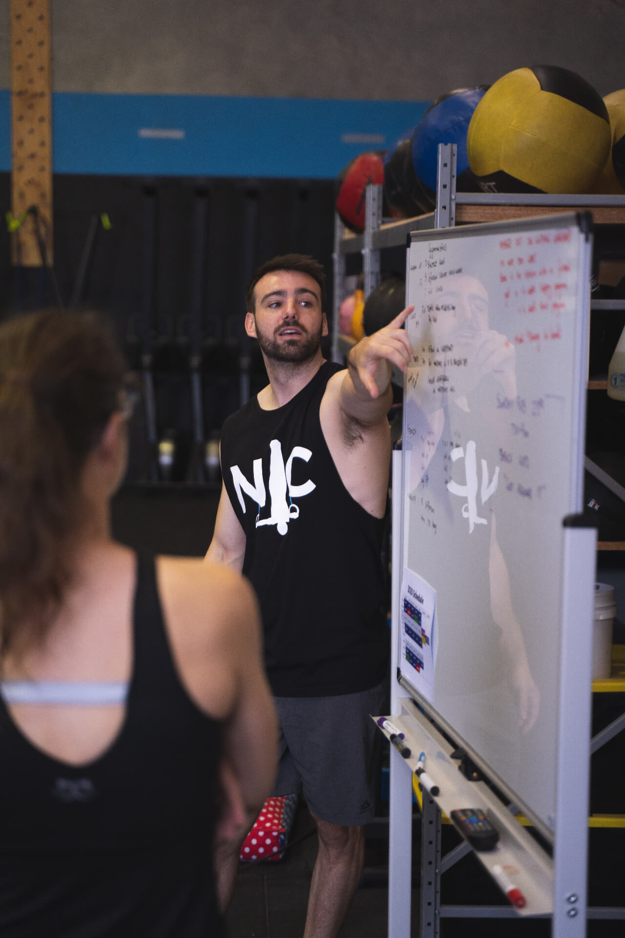 A coach briefing the class at the whiteboard