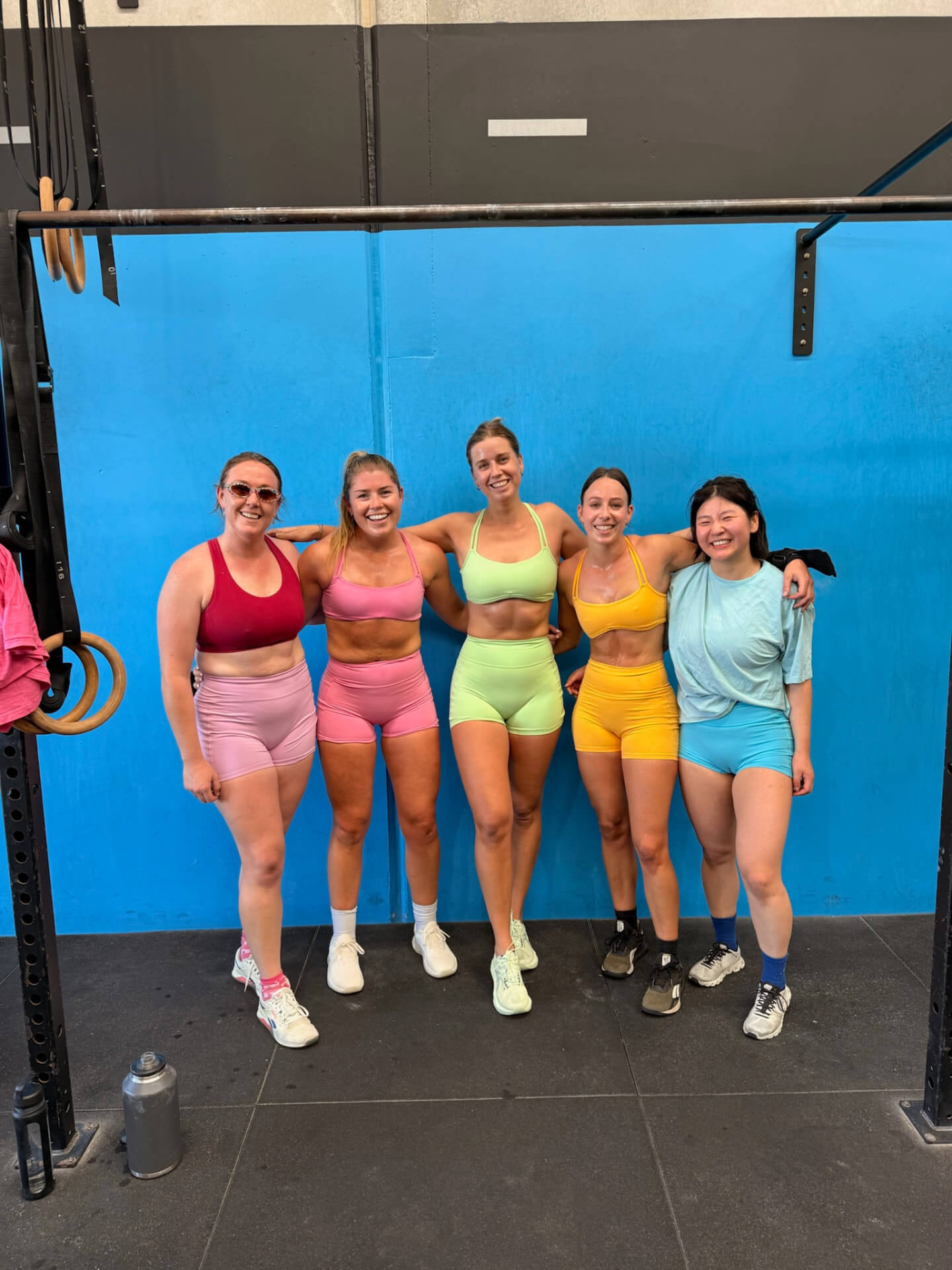 Members together in front of the blue wall