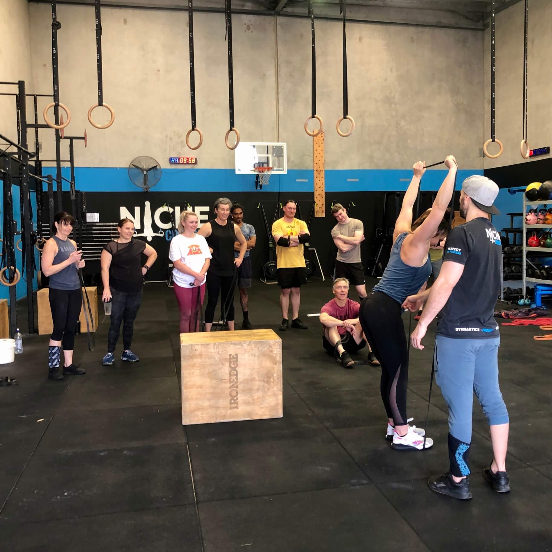 A coach demonstrating a movement to a class