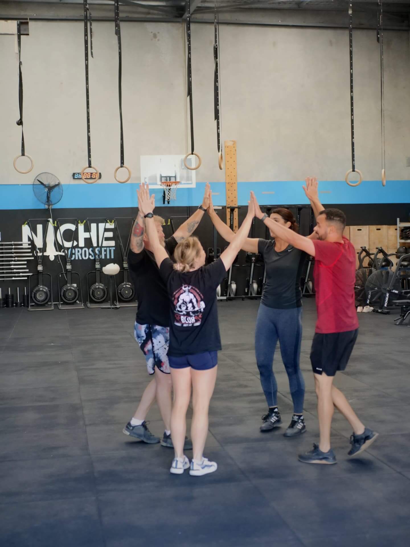 Members high-fiving at the end of a class