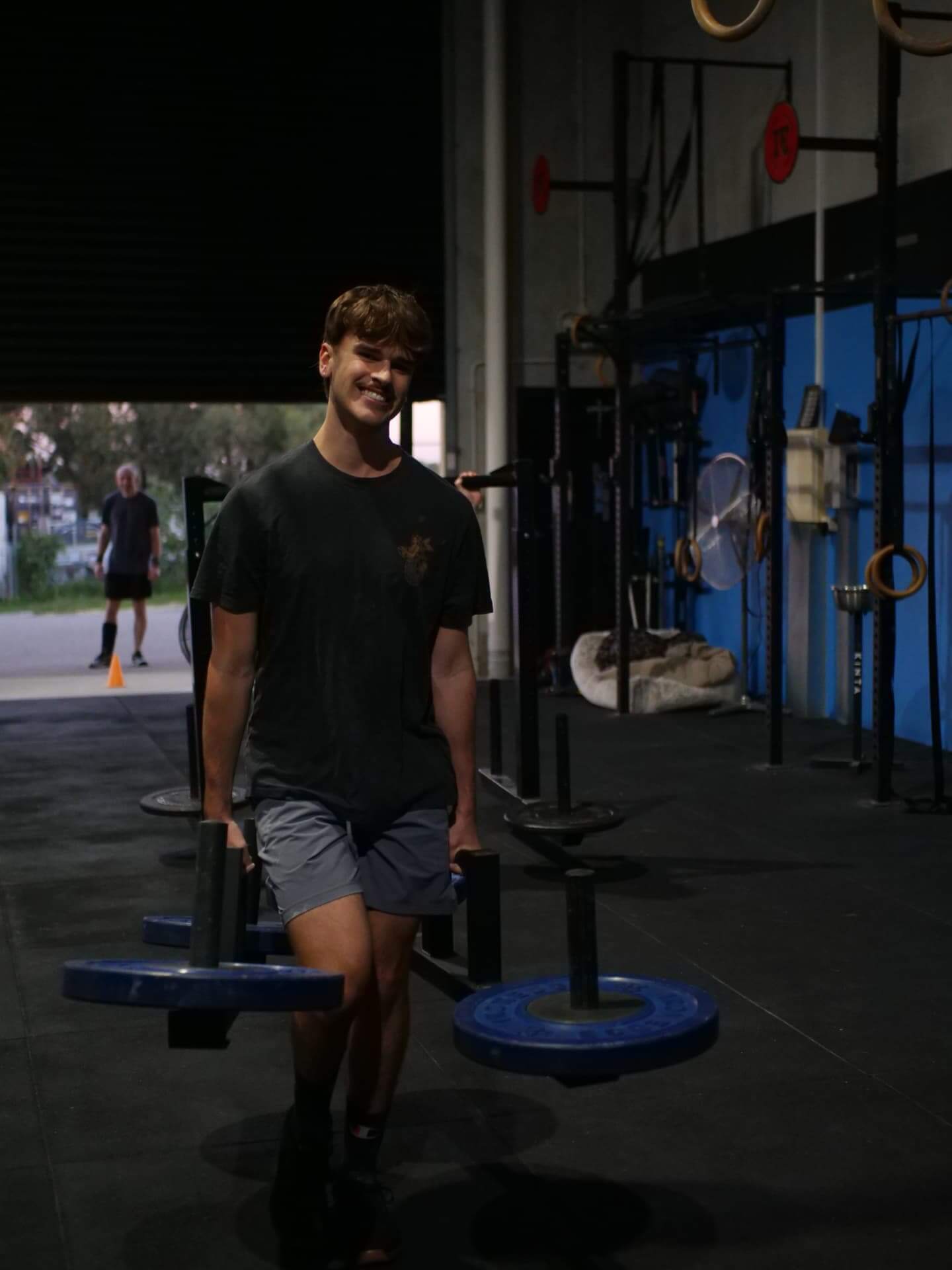Member smiling during a farmers carry